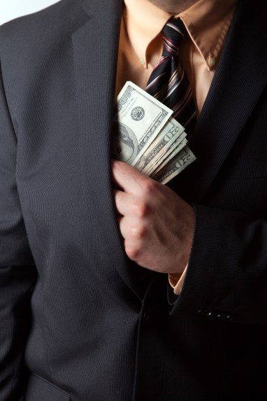 close-up-of-a-business-mans-hand-hiding-money-in-his-suit-jacket-pocket_SYVzguPRHj.jpg