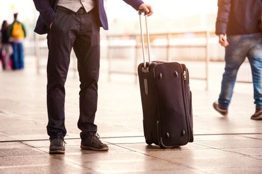 Unrecognizable businessman with luggage waiting at the airport